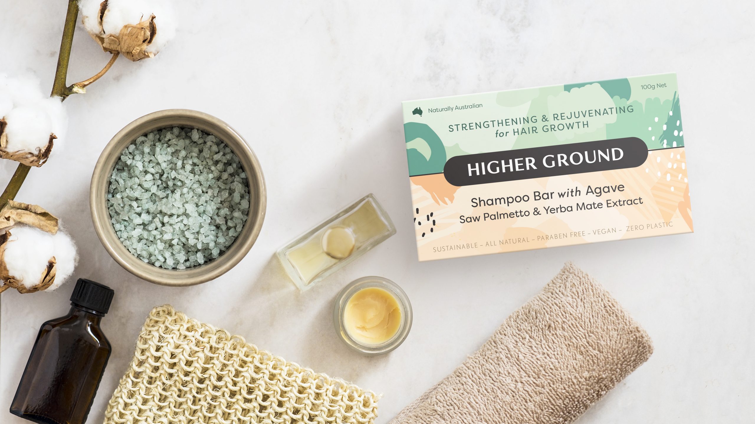 Higher Ground Shampoo Bar sitting on a marble bench top. Higher Ground is revolutionising hair care by taking plastic out of the equation. Their Shampoo bars are liquid-free so they're smaller and lighter to ship in packing that has zero plastic.Logotype, identity and pack design by Helium Design Melbourne. 